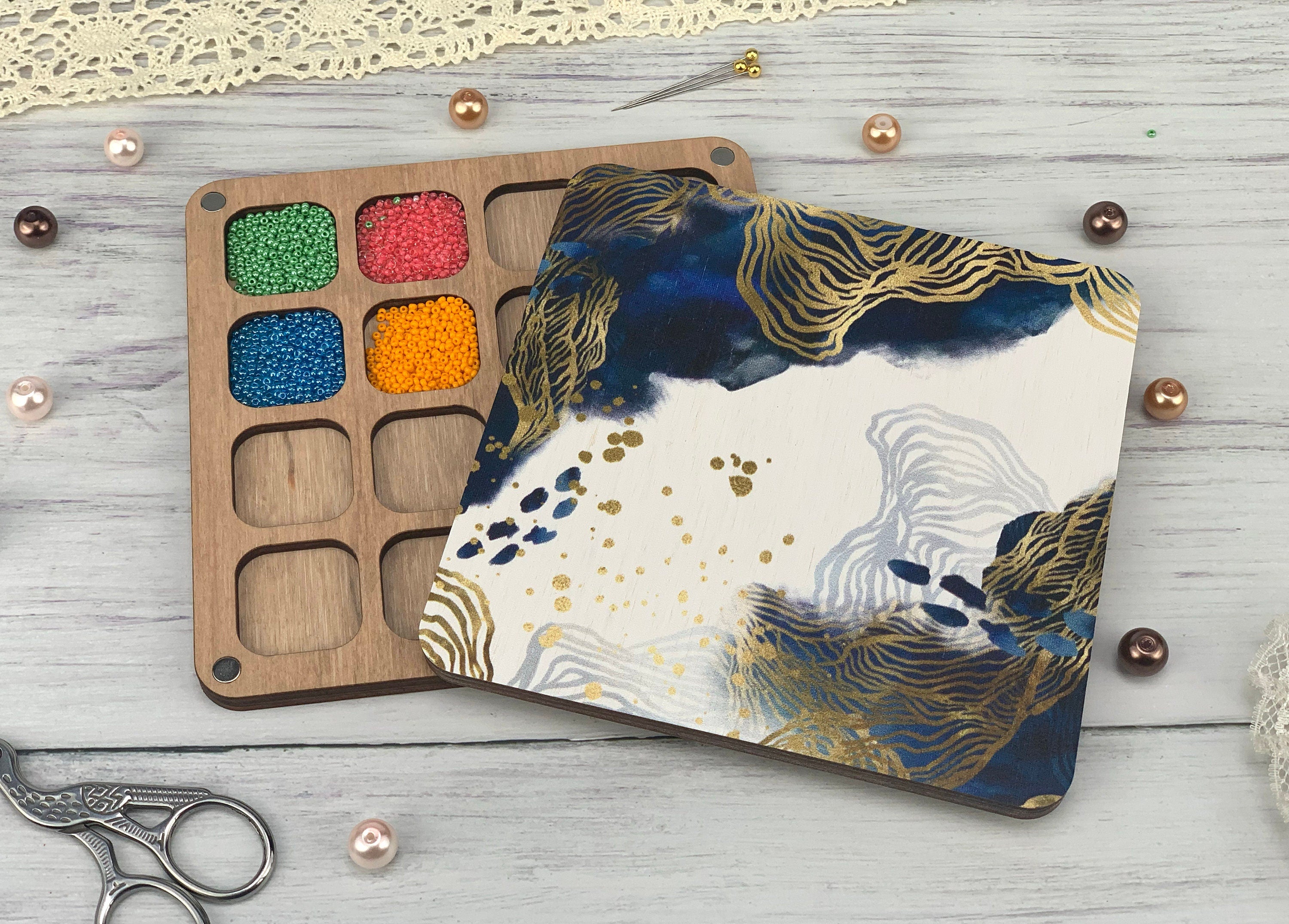 a wooden tray with paint and a pair of scissors